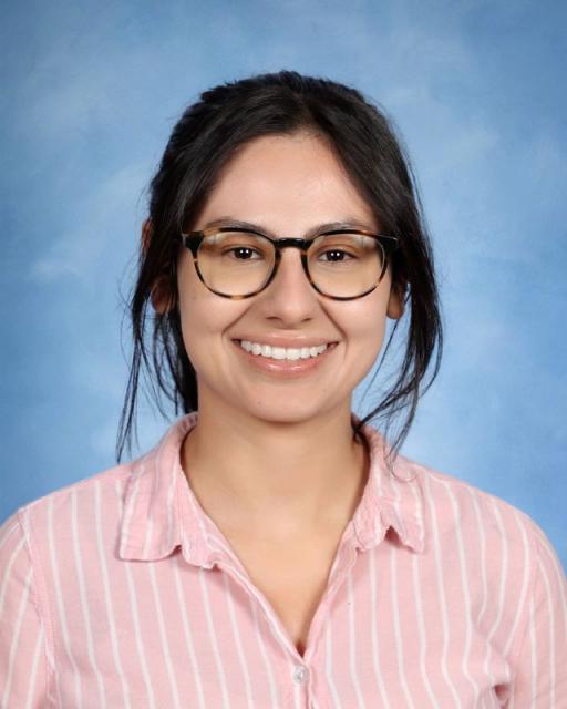 Studio headshot of Emily smiling