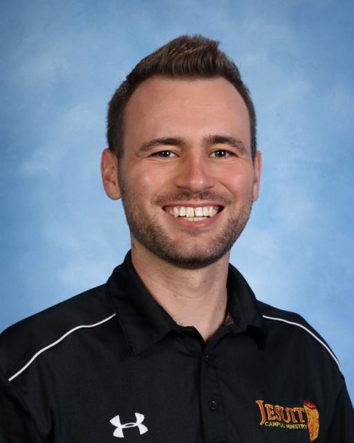 Studio headshot of smiling Adam