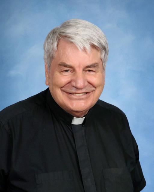 Studio headshot of Fr. Stiegeler smiling 