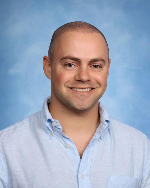 Studio head shot of smiling Carson